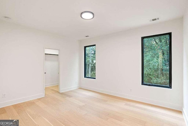 spare room featuring light wood-type flooring