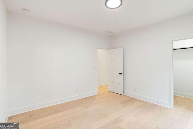 unfurnished bedroom with light wood-type flooring