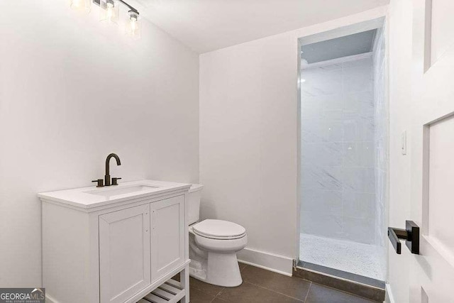 bathroom featuring tile patterned flooring, vanity, toilet, and a shower