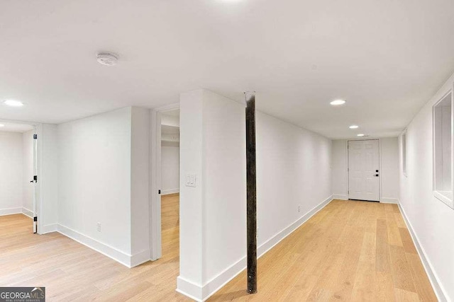 basement with light hardwood / wood-style flooring