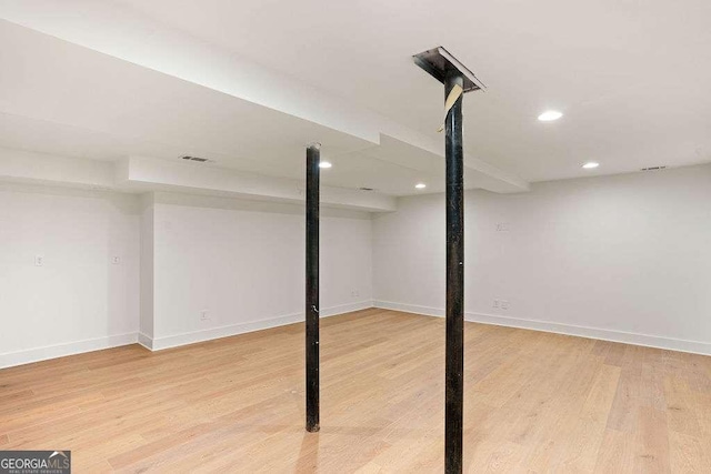 basement featuring hardwood / wood-style floors