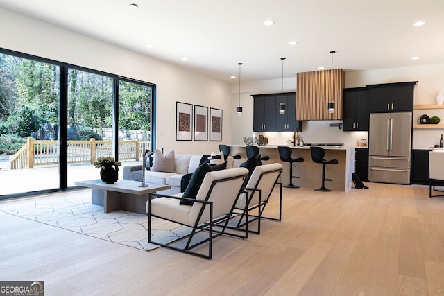 living room with sink and light hardwood / wood-style flooring