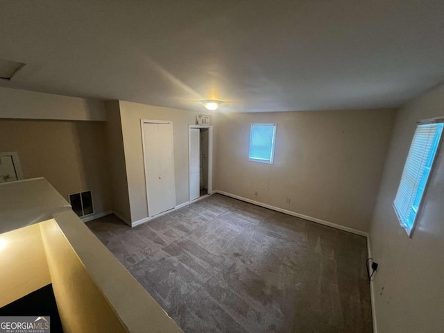 unfurnished bedroom featuring carpet flooring and a closet