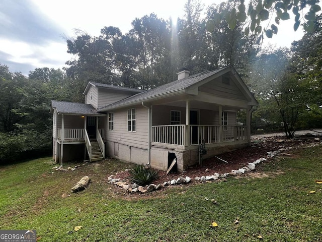 view of home's exterior with a porch and a yard