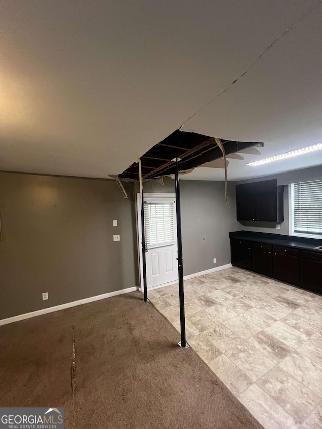 basement featuring light colored carpet