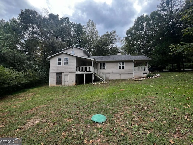 back of property featuring a lawn