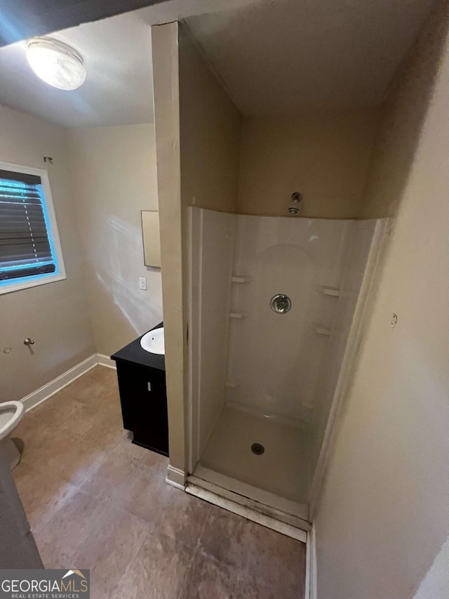 bathroom featuring vanity, toilet, and walk in shower