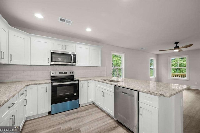 kitchen featuring white cabinets, appliances with stainless steel finishes, and sink