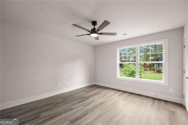 empty room featuring ceiling fan and wood-type flooring