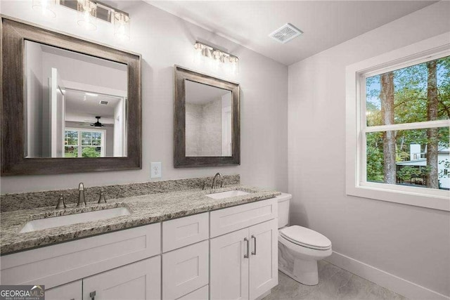 bathroom featuring plenty of natural light, ceiling fan, and toilet