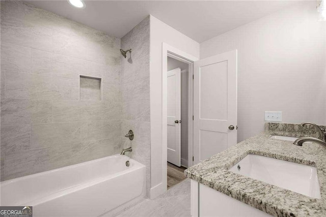 bathroom featuring vanity and tiled shower / bath combo