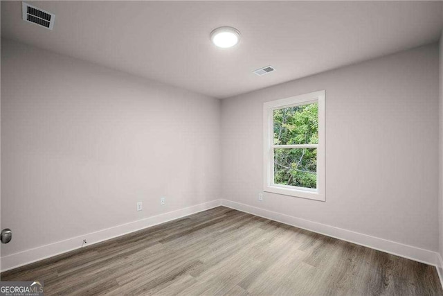 empty room with hardwood / wood-style flooring