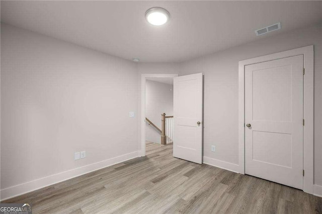 unfurnished bedroom featuring light wood-type flooring