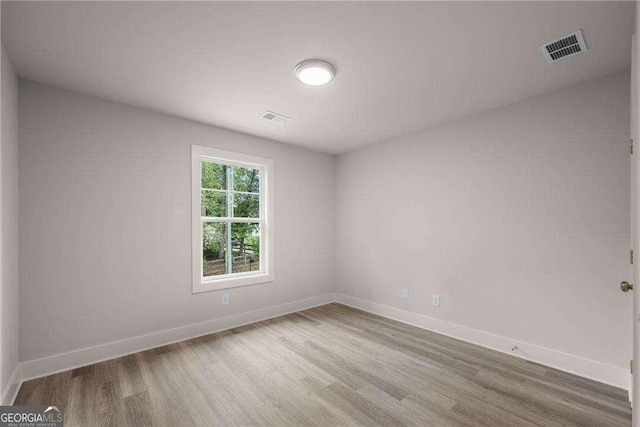 spare room with hardwood / wood-style flooring