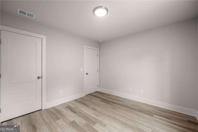 spare room with light hardwood / wood-style flooring