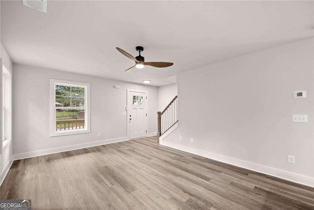 spare room with ceiling fan and light wood-type flooring