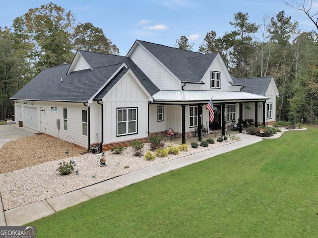 view of front facade with a porch, a garage, and a front yard