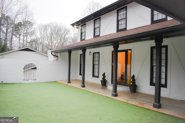 rear view of property featuring covered porch