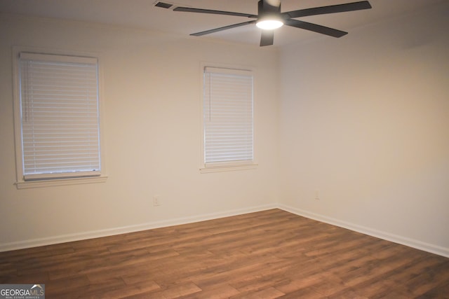 spare room featuring ceiling fan and dark wood-type flooring