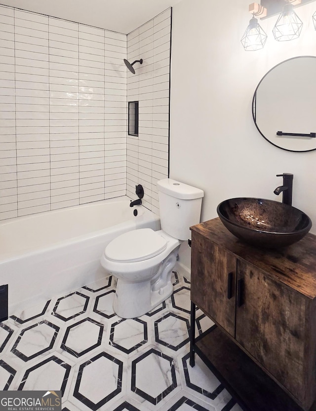 full bathroom with toilet, vanity, tile patterned floors, and tiled shower / bath