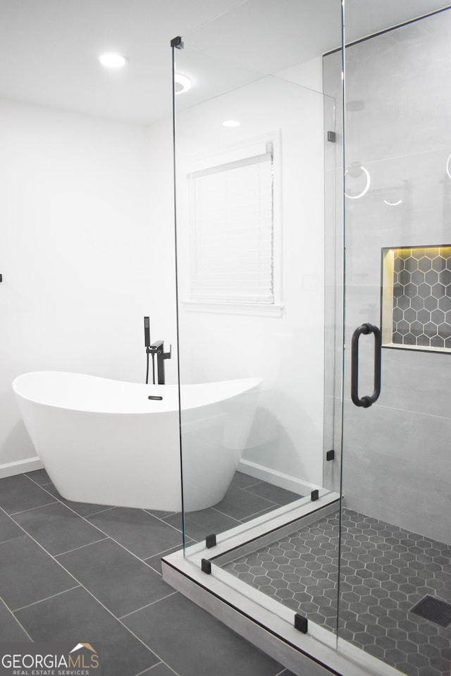 bathroom with tile patterned floors and plus walk in shower