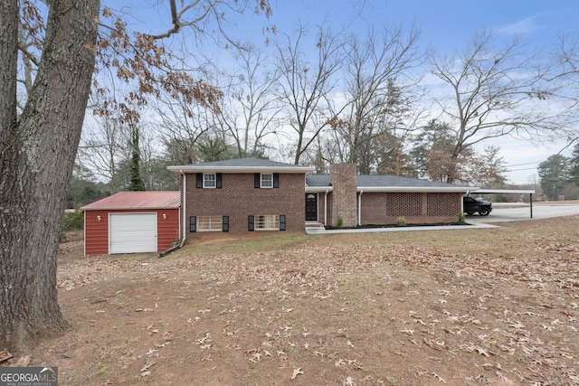 tri-level home with a garage, a carport, and an outdoor structure