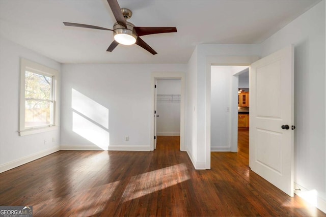 unfurnished room with ceiling fan and dark hardwood / wood-style flooring