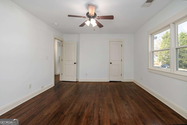 unfurnished bedroom featuring ceiling fan and dark hardwood / wood-style floors