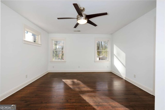 spare room with ceiling fan and dark wood-type flooring