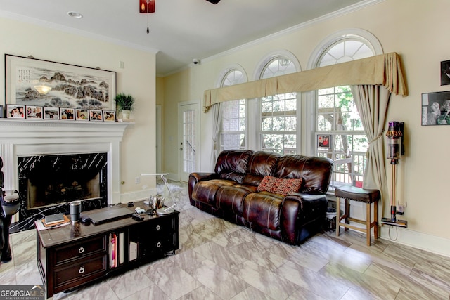 living room with ceiling fan, a fireplace, and ornamental molding