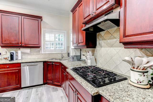 kitchen with black gas stovetop, dishwasher, light stone counters, and sink