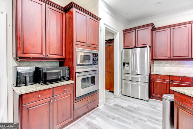 kitchen featuring decorative backsplash, light wood-type flooring, light stone countertops, ornamental molding, and stainless steel appliances