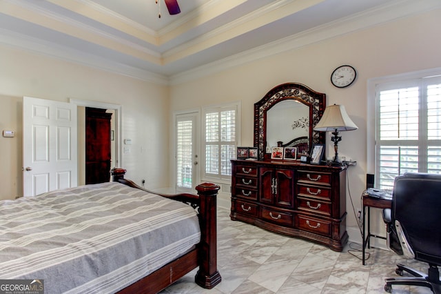 bedroom with a tray ceiling, ceiling fan, and ornamental molding