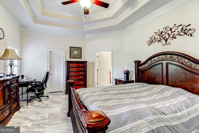 bedroom with ceiling fan, crown molding, and a tray ceiling