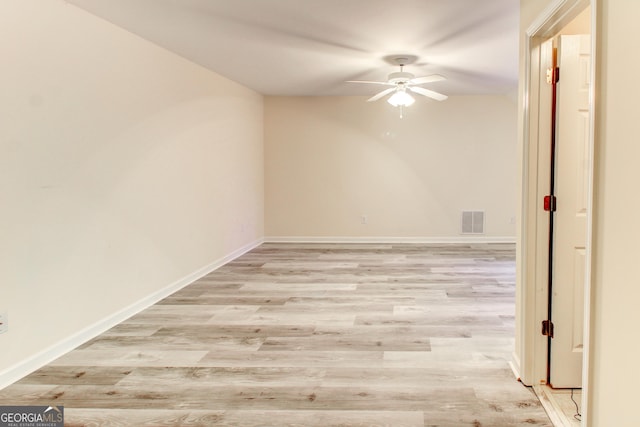 empty room featuring ceiling fan and light hardwood / wood-style floors