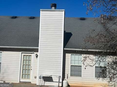 rear view of property featuring a patio area