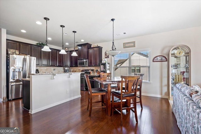 dining space featuring dark hardwood / wood-style floors