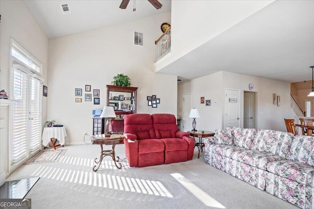 carpeted living room featuring ceiling fan and lofted ceiling