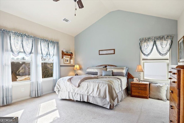 bedroom featuring ceiling fan, light carpet, and vaulted ceiling