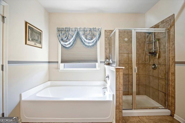 bathroom featuring tile patterned flooring and separate shower and tub