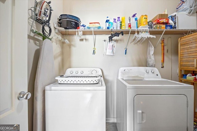 laundry room featuring washing machine and clothes dryer