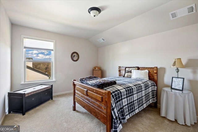 carpeted bedroom with lofted ceiling