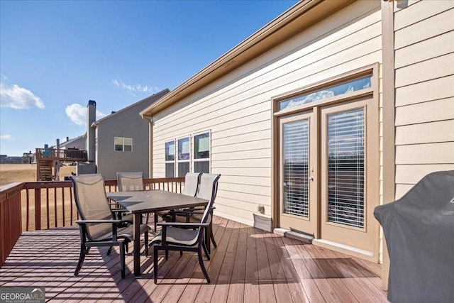 wooden terrace featuring a grill