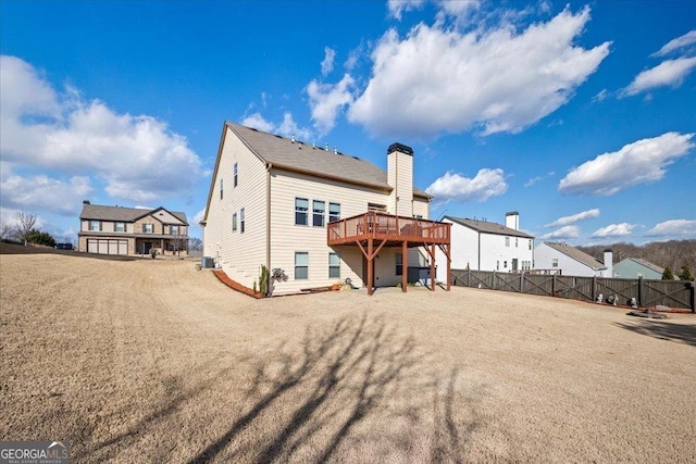 rear view of property with central air condition unit and a wooden deck