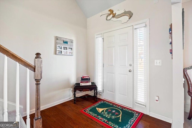 foyer entrance with wood-type flooring and lofted ceiling