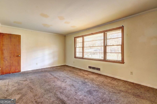 carpeted empty room featuring crown molding