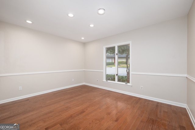 unfurnished room with wood-type flooring