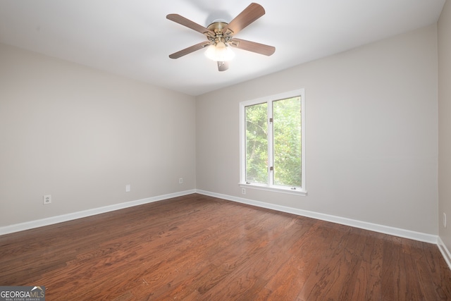 unfurnished room with dark hardwood / wood-style floors and ceiling fan