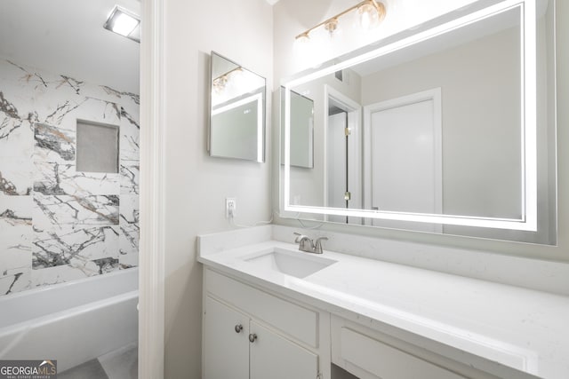 bathroom featuring vanity and tiled shower / bath