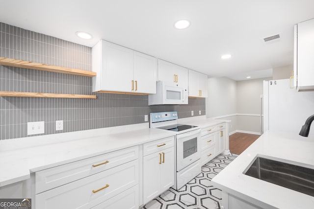 kitchen featuring white cabinets, decorative backsplash, white appliances, and sink